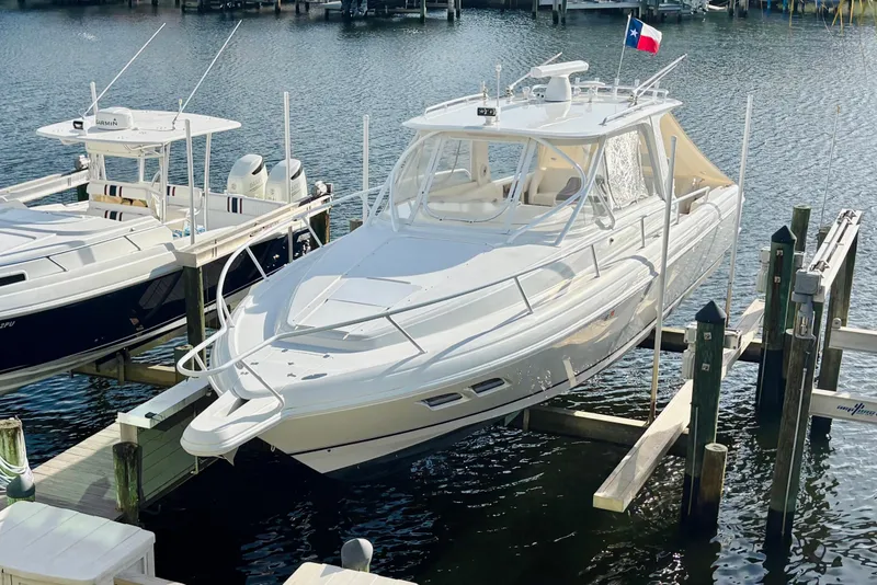 Slide: The Image of 2008 Intrepid 390 Sport Yacht docked on water, featuring sleek design and modern amenities. - 1