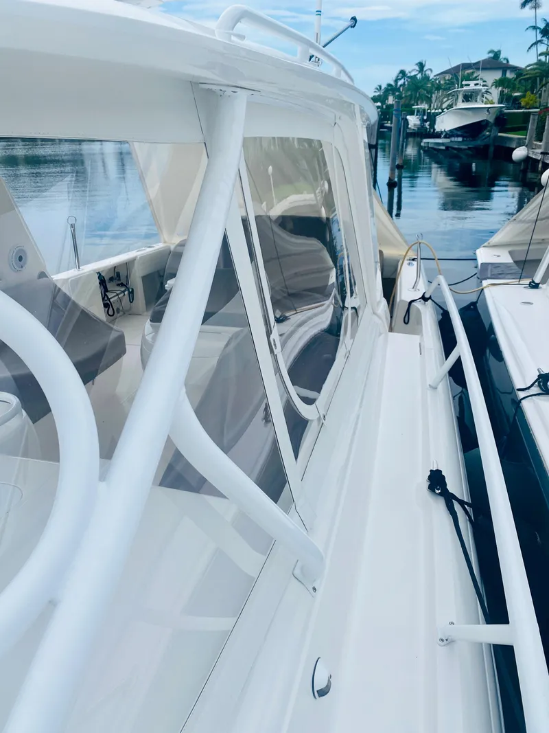 Slide: The Image of 2008 Intrepid 390 Sport Yacht docked at a marina. - 19