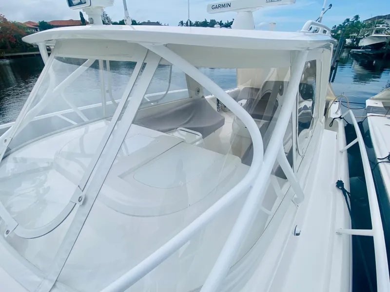 Slide: The Image of 2008 Intrepid 390 Sport Yacht docked, showcasing its sleek design and spacious cockpit. - 15