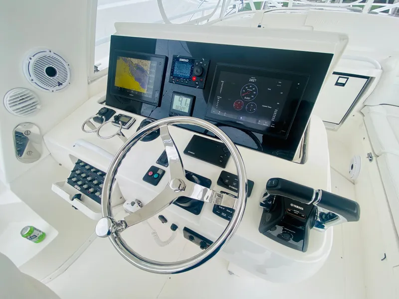 Slide: The Image of 2008 Intrepid 390 Sport Yacht helm with advanced navigation and control systems. - 38