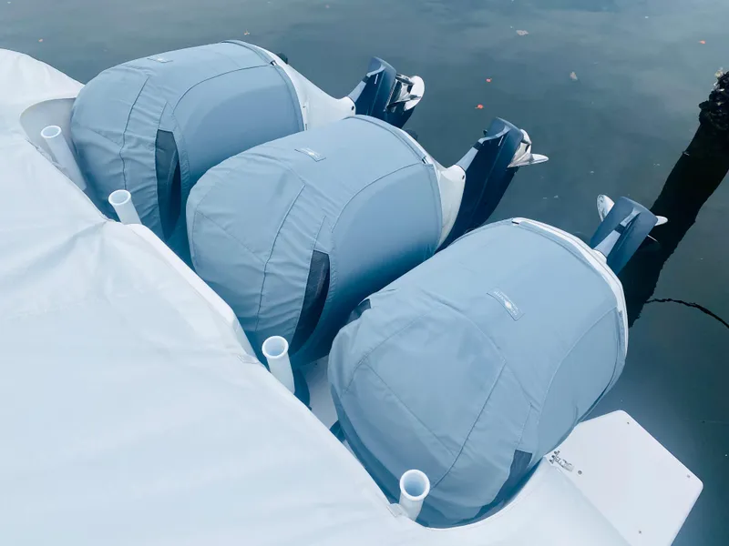 Slide: The Image of Three covered outboard motors on a 2008 Intrepid 390 Sport Yacht. - 7