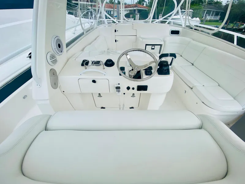 Slide: The Image of 2008 Intrepid 390 Sport Yacht helm with white leather seating and modern controls. - 35