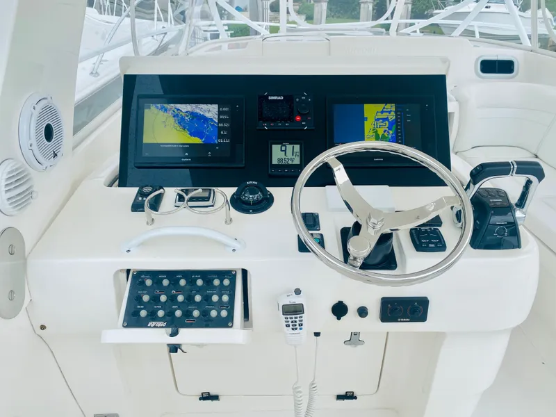 Slide: The Image of Helm station of a 2008 Intrepid 390 Sport Yacht with navigation screens and controls. - 37