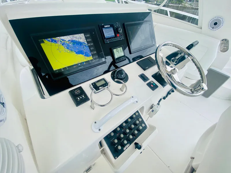 Slide: The Image of 2008 Intrepid 390 Sport Yacht helm with navigation screens and steering wheel. - 39