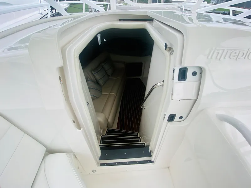 Slide: The Image of 2008 Intrepid 390 Sport Yacht cabin entrance with white interior and seating. - 51