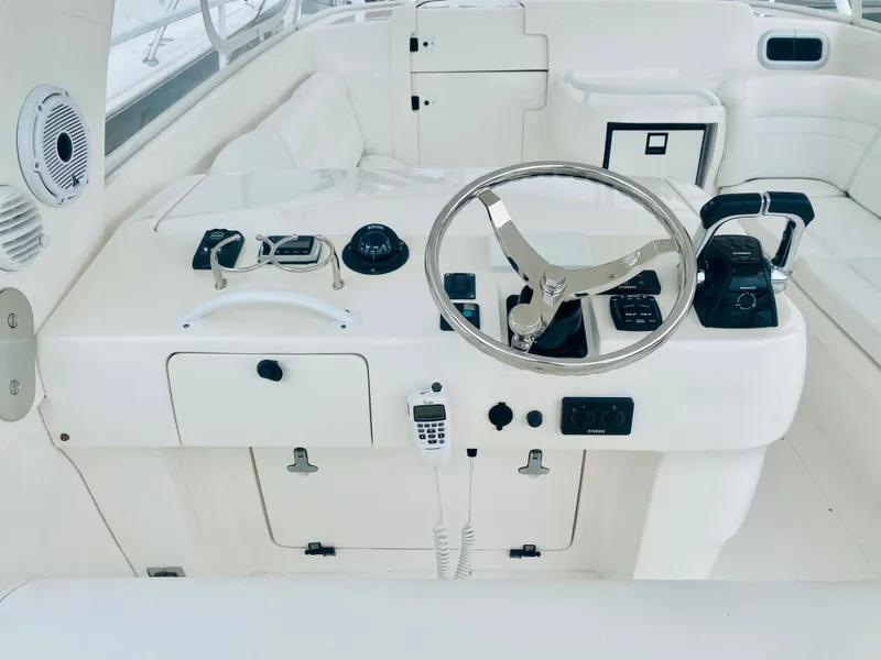 Slide: The Image of 2008 Intrepid 390 Sport Yacht helm station with steering wheel and controls. - 36
