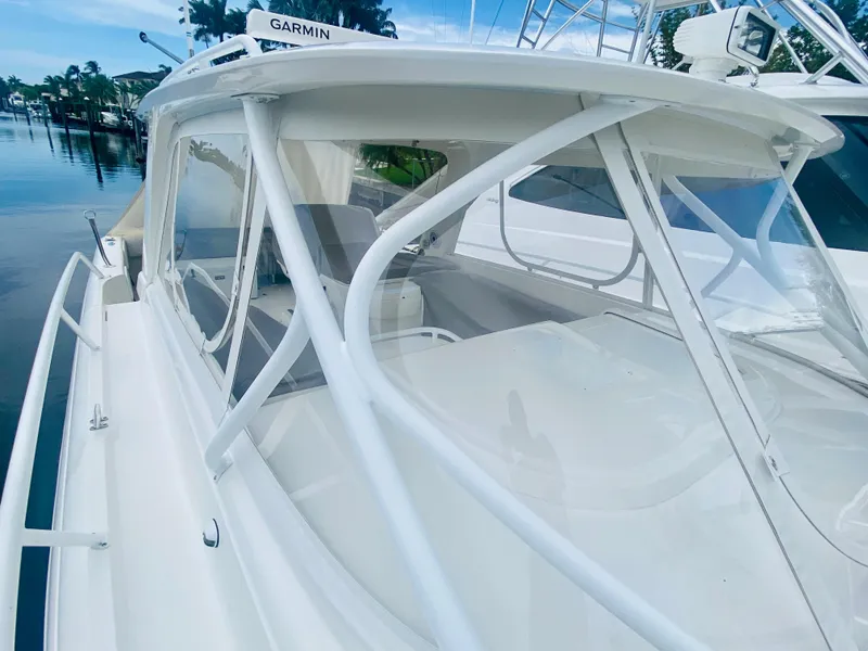 Slide: The Image of 2008 Intrepid 390 Sport Yacht with Garmin navigation, docked by the water. - 14