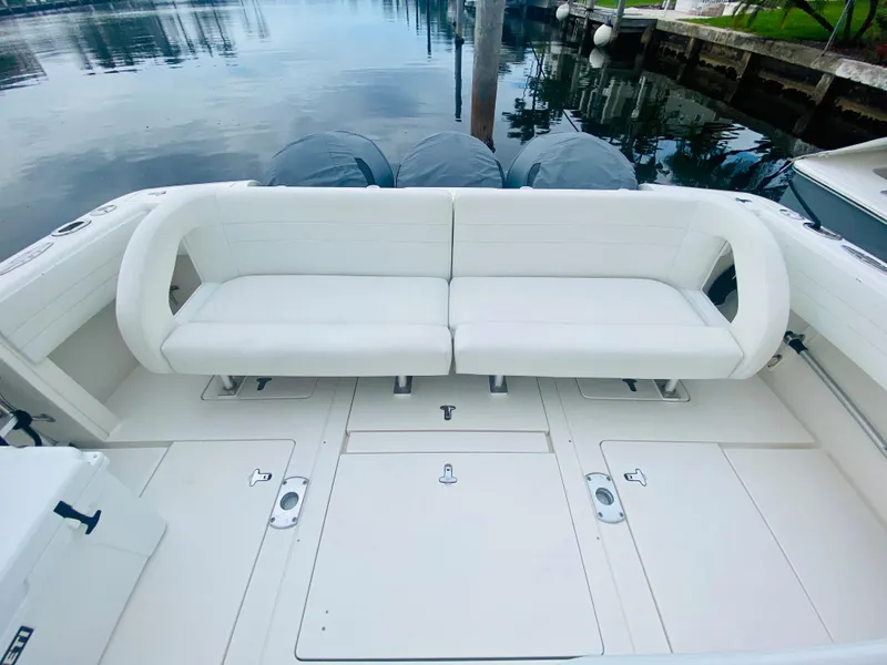 Slide: The Image of 2008 Intrepid 390 Sport Yacht with white seating and triple outboard motors. - 27