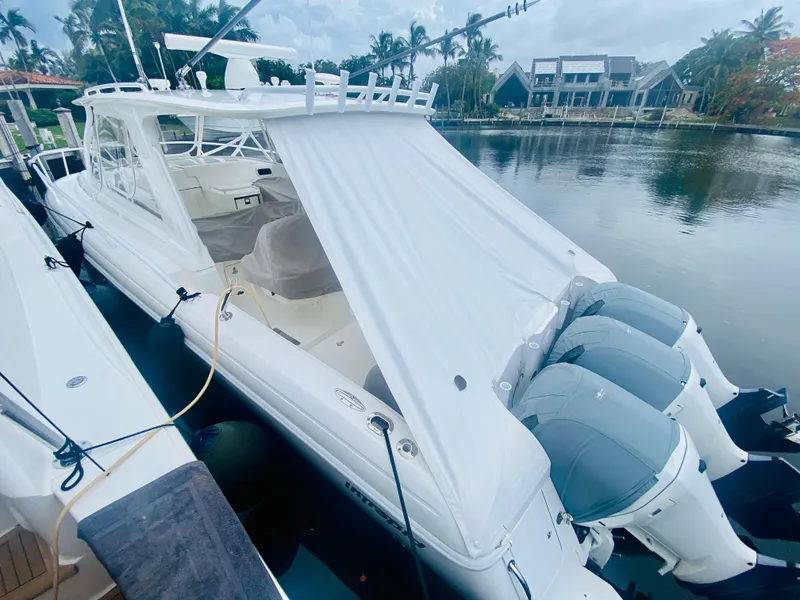 Slide: The Image of 2008 Intrepid 390 Sport Yacht docked by waterfront homes. - 6