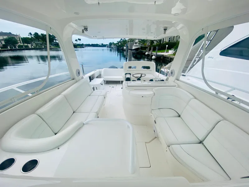 Slide: The Image of 2008 Intrepid 390 Sport Yacht with spacious white seating and scenic waterfront view. - 21