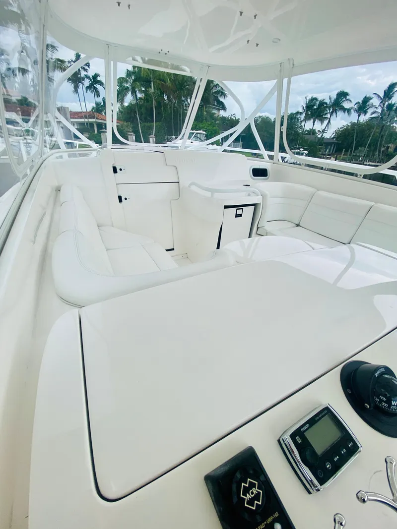 Slide: The Image of 2008 Intrepid 390 Sport Yacht interior with white seating and control panel. - 30