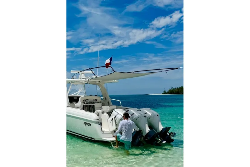 Slide: The Image of 2008 Intrepid 390 Sport Yacht anchored in clear turquoise water, under a sunny blue sky. - 4