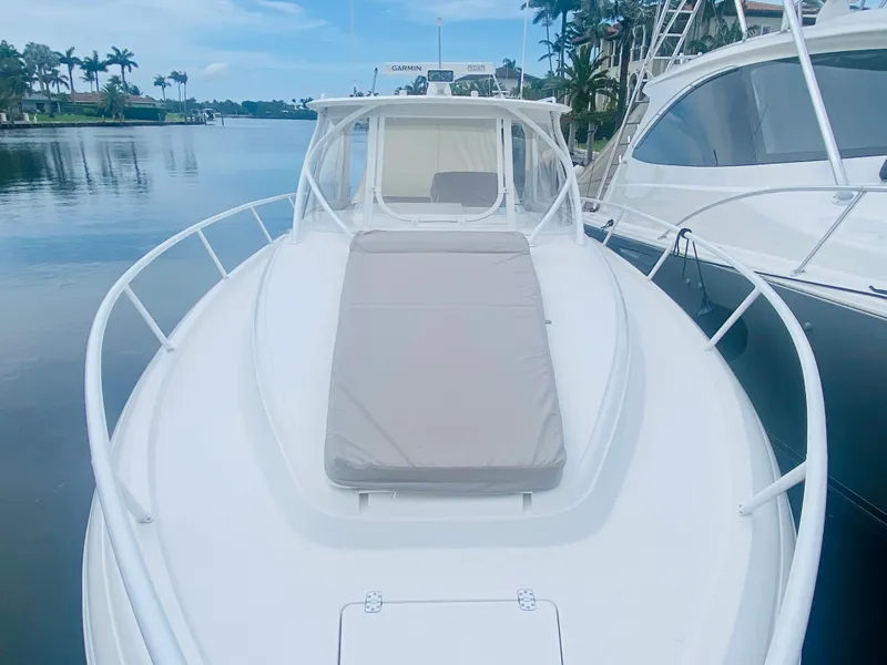 Slide: The Image of 2008 Intrepid 390 Sport Yacht docked in a serene marina. - 12