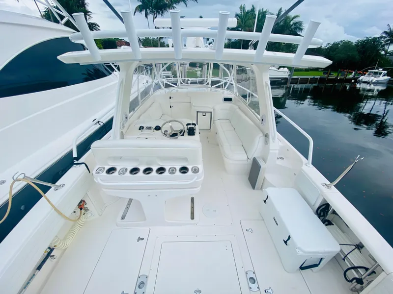 Slide: The Image of 2008 Intrepid 390 Sport Yacht, spacious deck, white interior, docked by the water. - 23