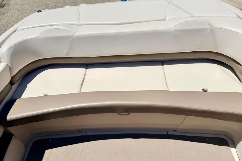 Slide: The Image of 2002 Larson LXi 210 boat interior with beige seating and upholstery. - 30