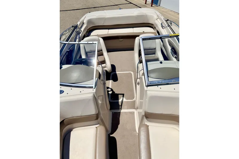 Slide: The Image of 2002 Larson LXi 210 boat interior with beige seating and carpeted floor. - 56