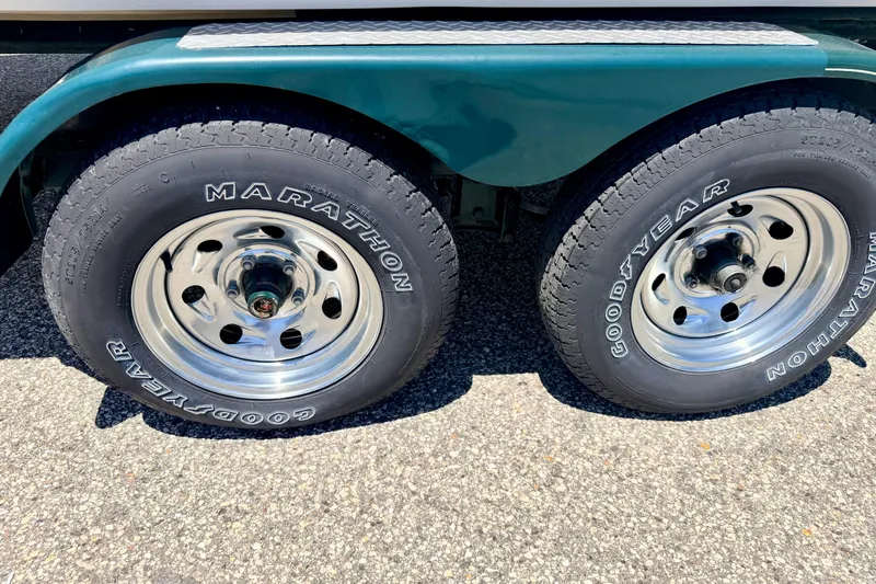 Slide: The Image of Trailer wheels with Goodyear Marathon tires on a 2002 Larson LXi 210 boat trailer. - 66