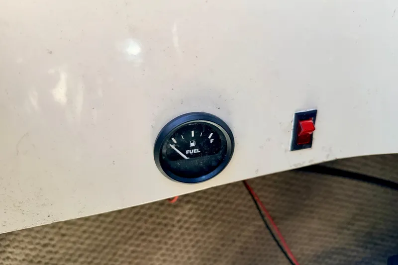 Slide: The Image of Fuel gauge and switch on 2002 Larson LXi 210 boat dashboard. - 28