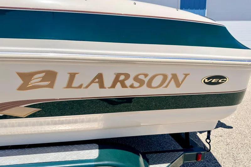 Slide: The Image of 2002 Larson LXi 210 boat with VEC technology, featuring elegant branding on the side. - 11