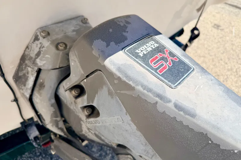 Slide: The Image of Volvo Penta SX outdrive on a 2002 Larson LXi 210 boat, showing wear. - 16