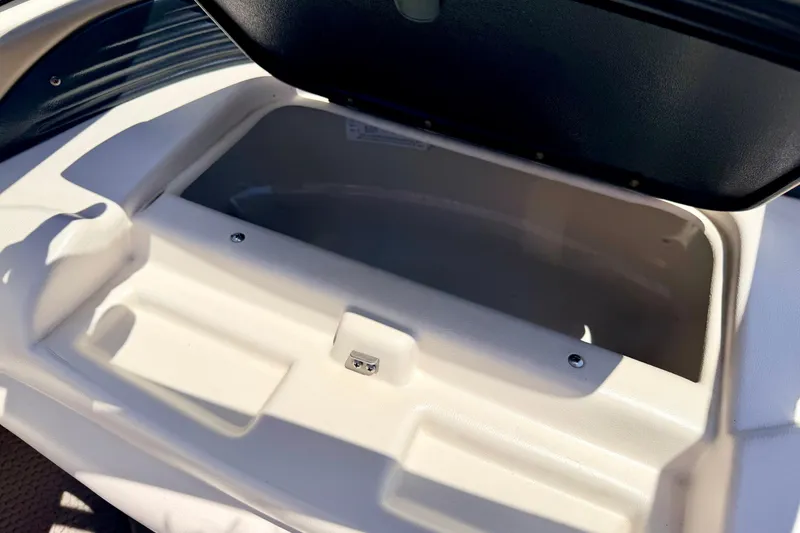 Slide: The Image of Open storage compartment on a 2002 Larson LXi 210 boat, showcasing interior space. - 45