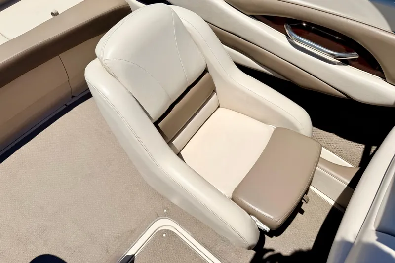 Slide: The Image of 2002 Larson LXi 210 boat interior with beige and brown seating. - 46