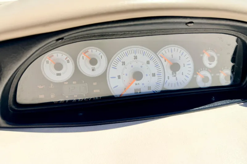 Slide: The Image of Dashboard of a 2002 Larson LXi 210 boat, featuring speedometer and fuel gauges. - 33