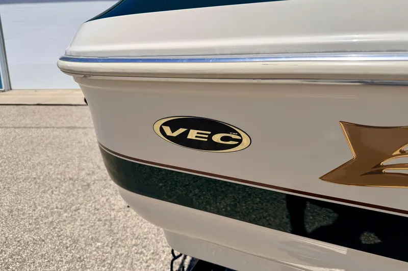 Slide: The Image of 2002 Larson LXi 210 boat with VEC logo on the side. - 10