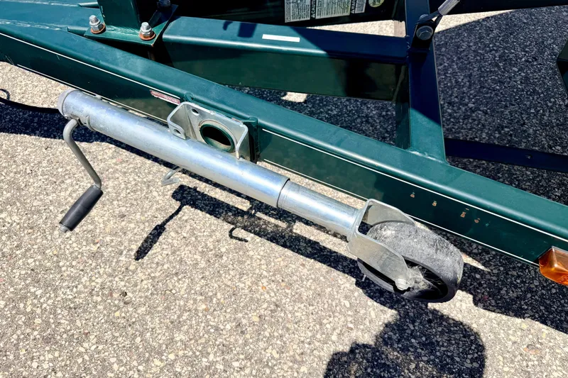 Slide: The Image of Trailer jack wheel on a 2002 Larson LXi 210 boat trailer. - 64
