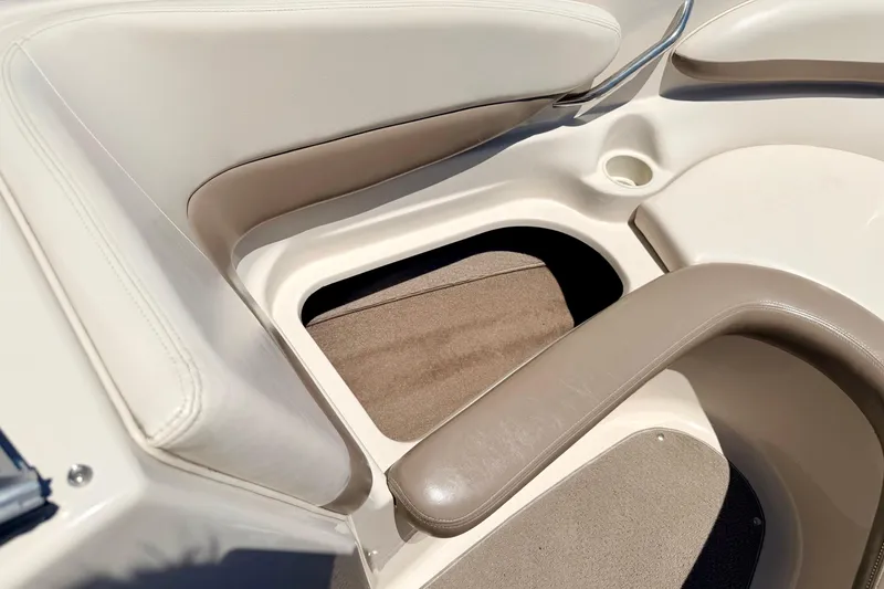 Slide: The Image of 2002 Larson LXi 210 boat interior with beige seating and storage compartment. - 51
