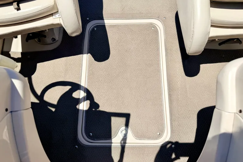 Slide: The Image of Interior of a 2002 Larson LXi 210 boat showing seating and floor compartment. - 57
