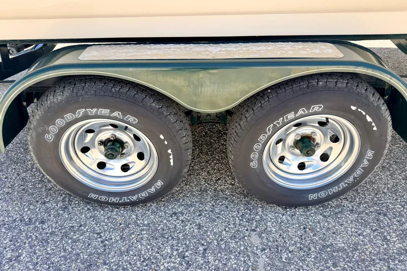 Slide: The Image of Trailer wheels with Goodyear Marathon tires on a 2002 Larson LXi 210 boat trailer. - 69