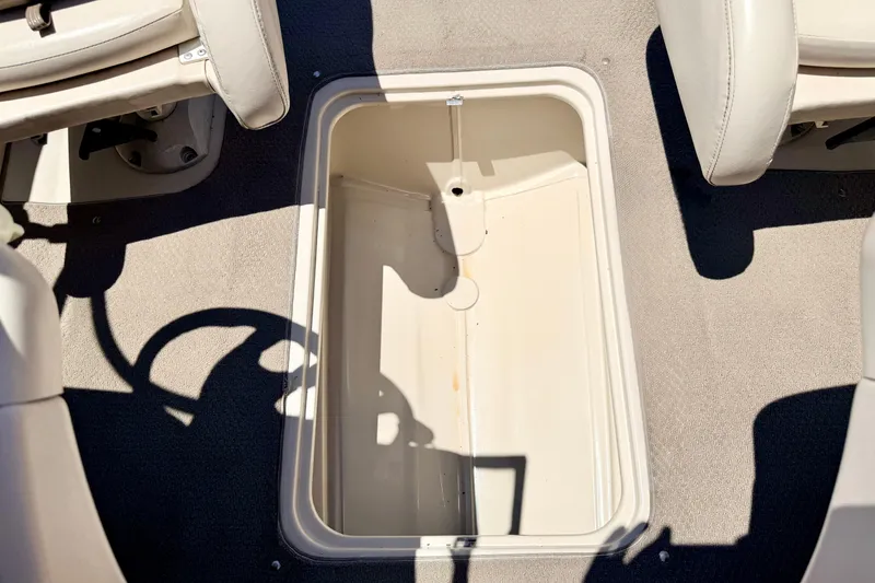 Slide: The Image of 2002 Larson LXi 210 boat interior storage compartment with beige seating and carpet. - 58