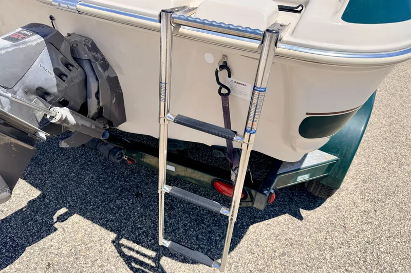 Slide: The Image of Rear view of a 2002 Larson LXi 210 boat with ladder and Volvo engine. - 20