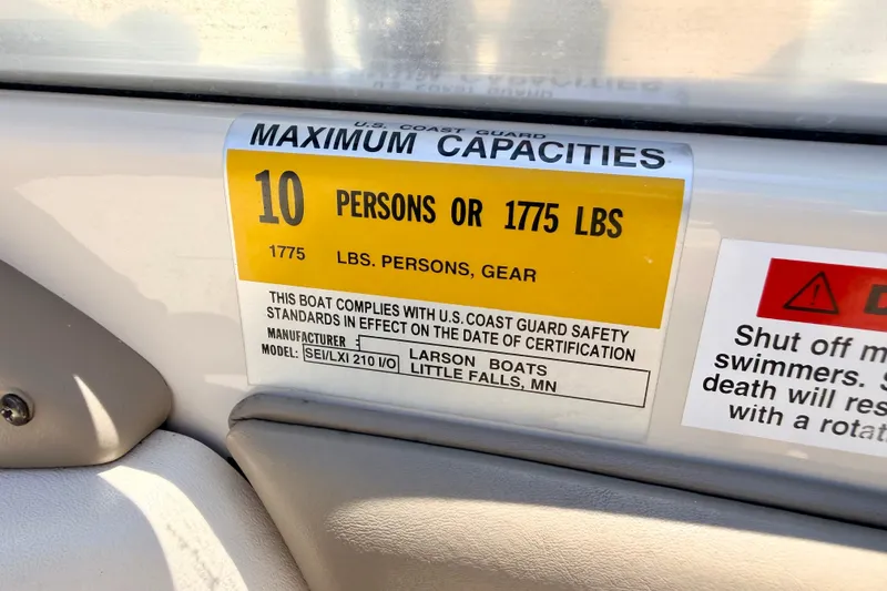 Slide: The Image of 2002 Larson LXi 210 capacity label: 10 persons or 1775 lbs, U.S. Coast Guard compliant. - 38