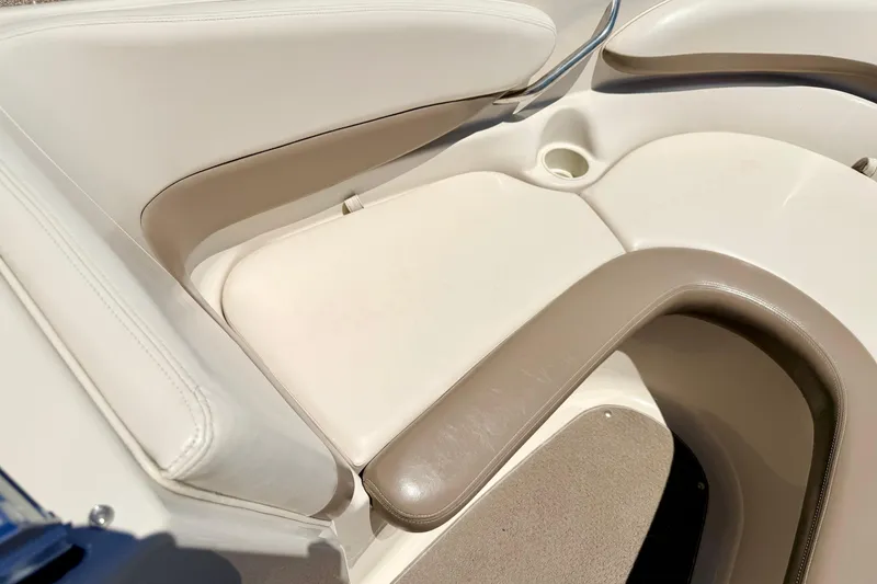 Slide: The Image of 2002 Larson LXi 210 boat interior with beige seating and cup holder. - 50