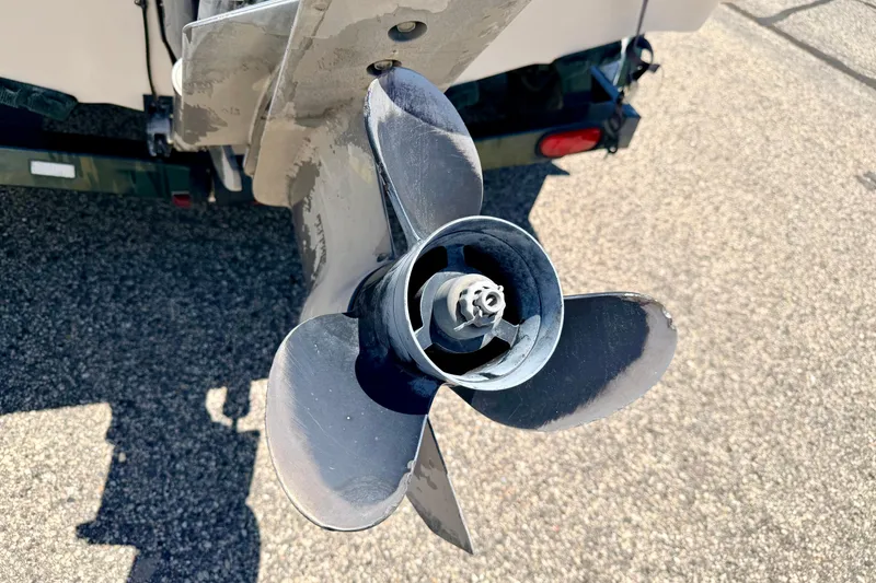 Slide: The Image of Close-up of a 2002 Larson LXi 210 boat propeller on asphalt background. - 15