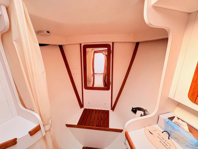 Slide: The Image of Interior of a 1994 Catalina 42 with wood trim and a mirror. - 28