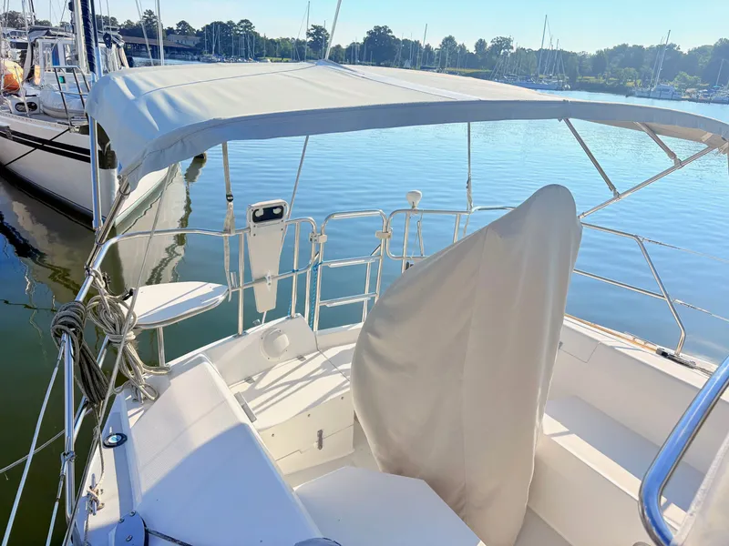 Slide: The Image of The image shows the cockpit of a 1994 Catalina 42, docked on calm water. - 3