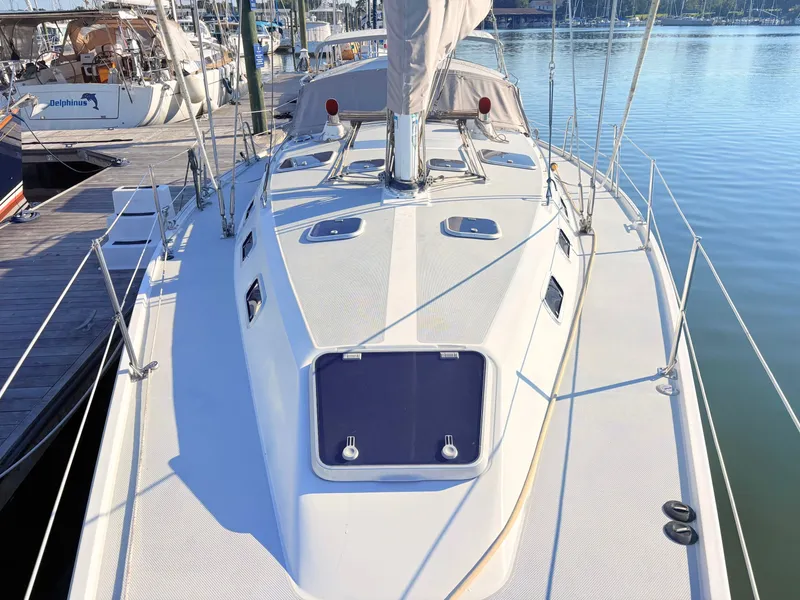 Slide: The Image of The image shows the deck of a 1994 Catalina 42, docked at a marina. - 15