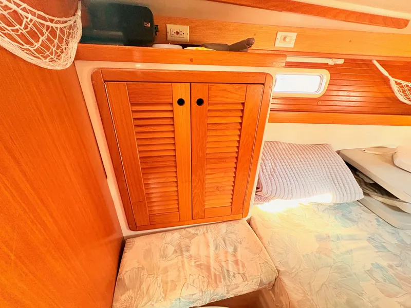 Slide: The Image of A cozy cabin bed with wooden walls and a window. A cabinet with louvered doors is visible. - 40