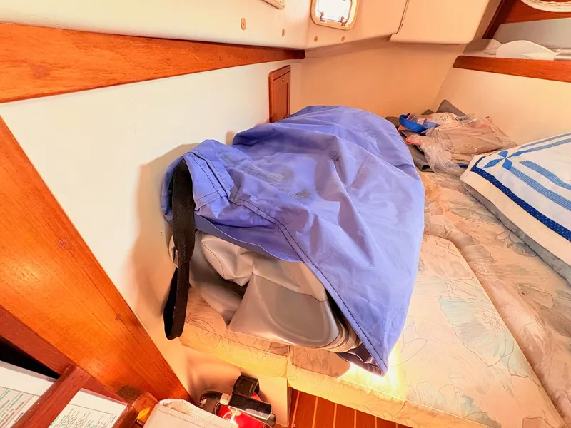 Slide: The Image of Interior of a 1994 Catalina 42 with a blue bag on a bed. - 36