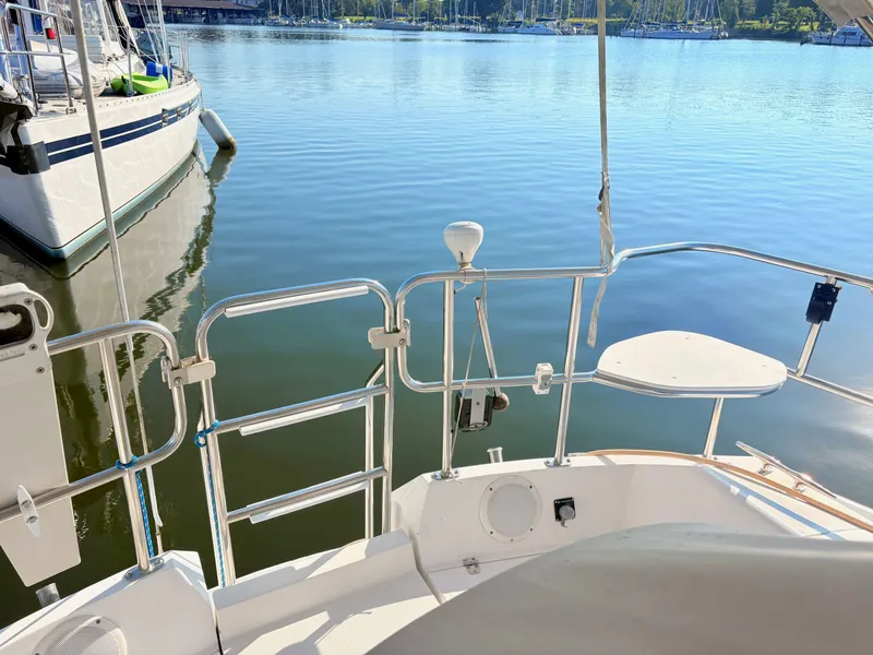 Slide: The Image of The image shows the stern of a 1994 Catalina 42, docked in a calm marina. - 5