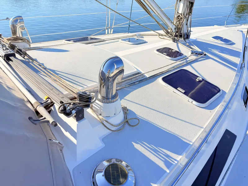 Slide: The Image of The deck of a 1994 Catalina 42 with shiny metal fittings and ropes. - 11