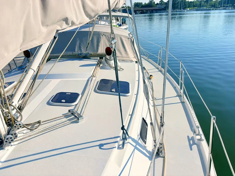Slide: The Image of The deck of a 1994 Catalina 42 with clean lines and sailing equipment. - 16
