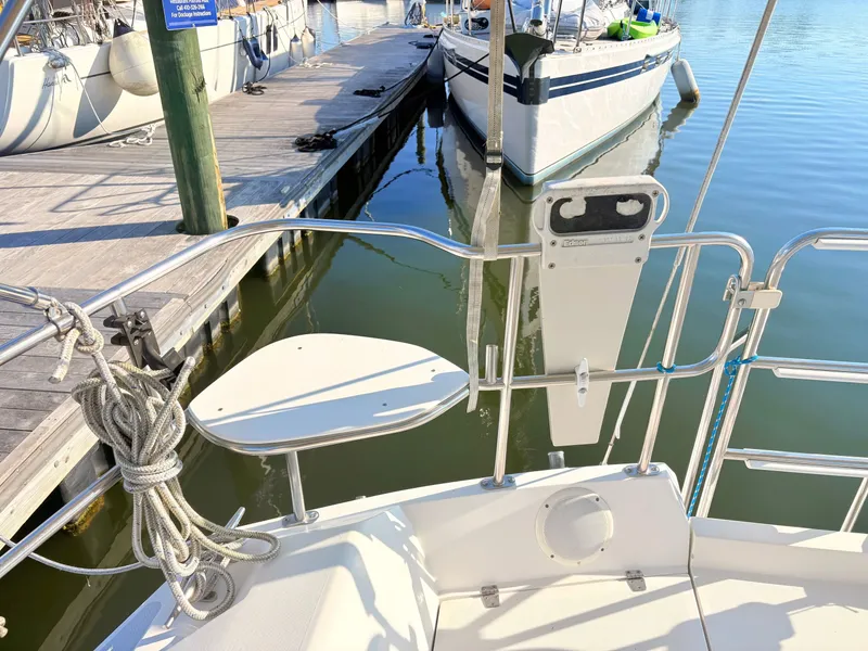 Slide: The Image of The image shows the stern of a sailboat at a dock. There's a swim platform and railing. - 4