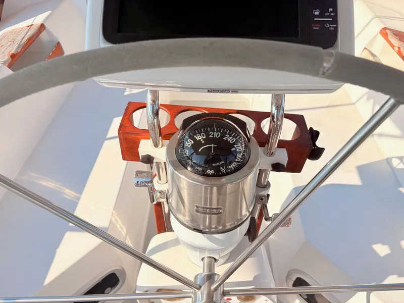 Slide: The Image of The image shows the helm of a 1994 Catalina 42 with a compass. - 8
