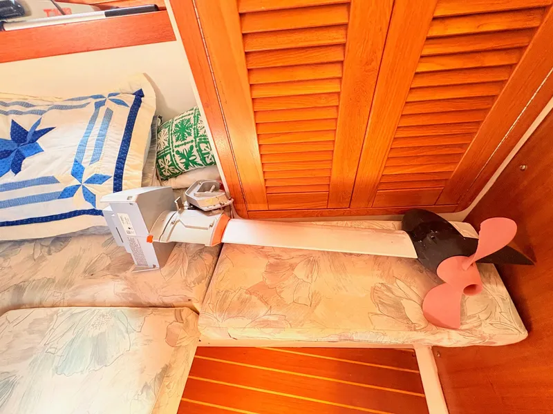 Slide: The Image of A propeller rests on a cushioned bench inside a boat with wooden walls. - 35