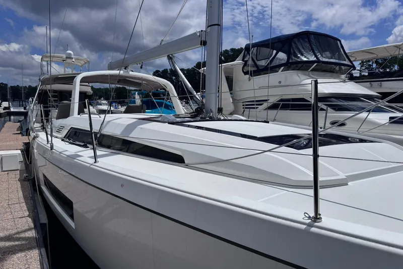 Slide: The Image of 2022 Beneteau Oceanis 46.1 sailboat docked at marina under cloudy sky. - 8