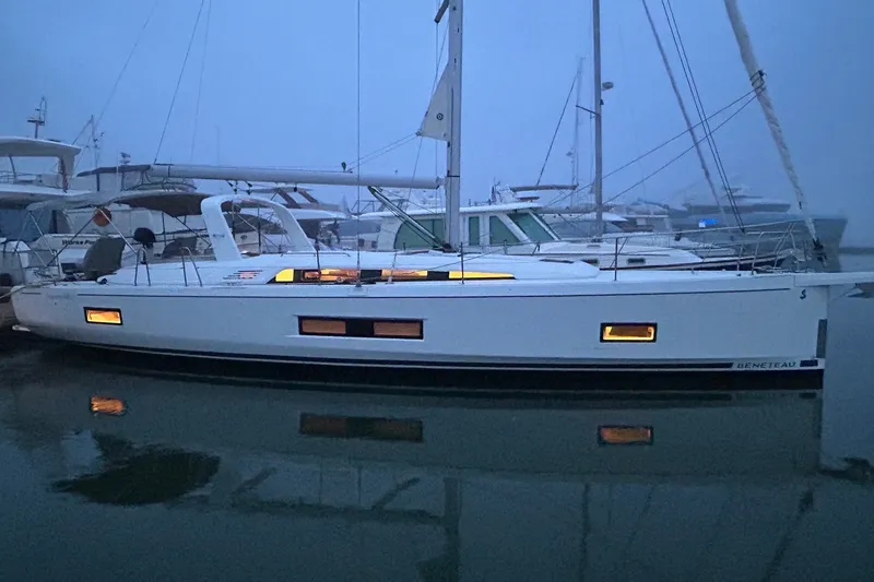 The Image of 2022 Beneteau Oceanis 46.1 yacht docked at marina during twilight. - 0